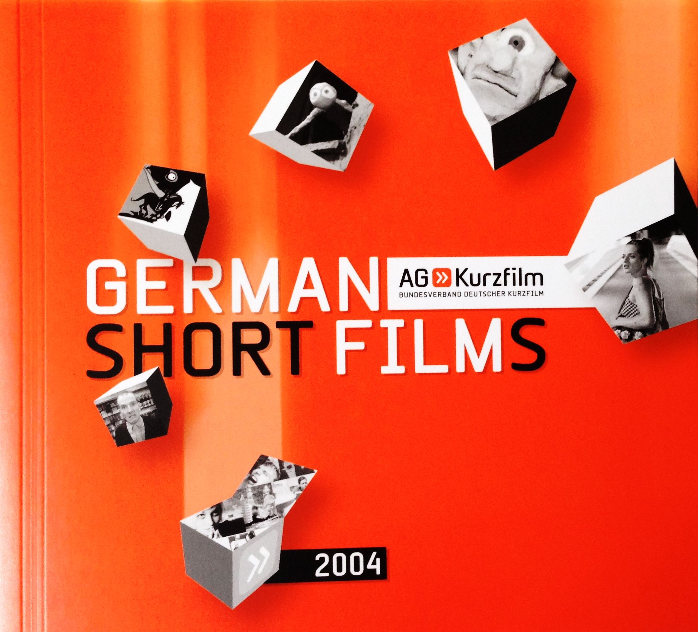 Cover des ersten Kurzfilmkatalogs, Filmbilder kreisförmig angeordnet auf orangem Hintergrund.